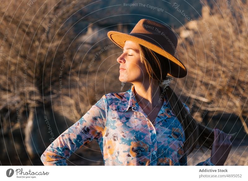 Woman in ht standing in countryside woman style nature sunlight feminine hat enjoy appearance rural female headwear headdress dreamy outfit apparel charming