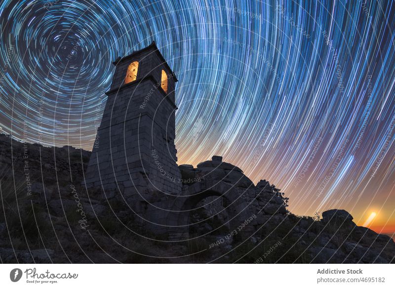 Old tower with glowing star lights at night time Monastery medieval ancient countryside starry old obsolete effect stone construction historic facade history