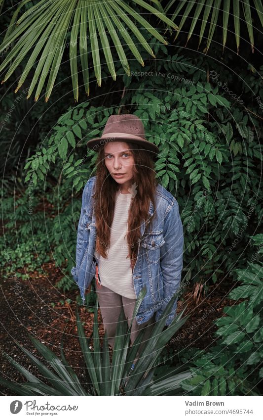 portrait of a girl in the jungle hat woman beauty fashion model face people person hair cowgirl smiling smile cowboy western one summer lady brunette nature