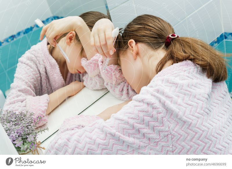 sleeping teen girl with a toothbrush in hands sleepy early morning tooth-brush tooth brush tired weary hold slumber fingers back lying stand shelf evening clean