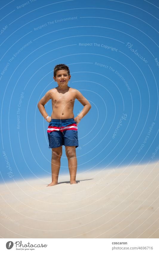 Portrait of a cute boy on a dune of a beach adorable blue blue sky bolonia cadiz caribbean caucasian cheerful child childhood coastline de freedom fun happiness