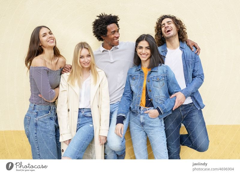 Group of diverse positive friends in city portrait group together friendship unity hug cheerful embrace multiethnic multiracial black african american hispanic