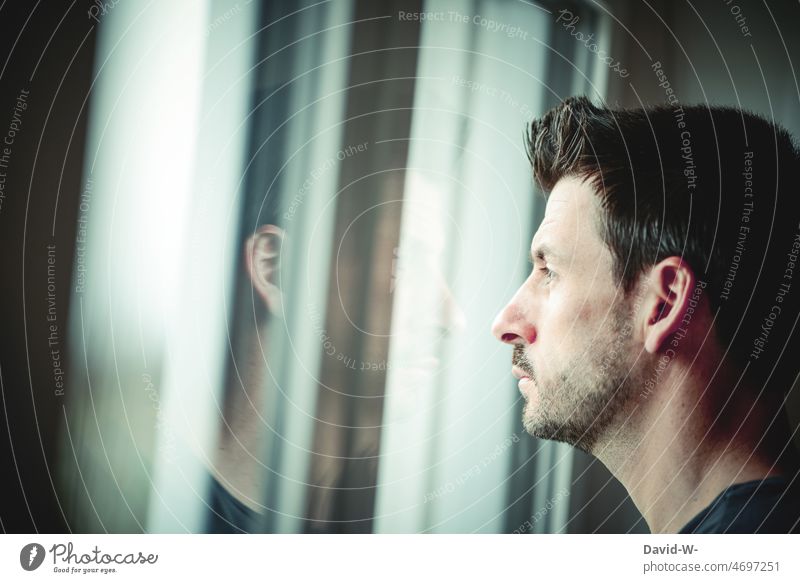 Man looks out of the window bilk Window void thoughts Fear of the future Meditative ponder Worries Profile Face reflection Window pane portrait