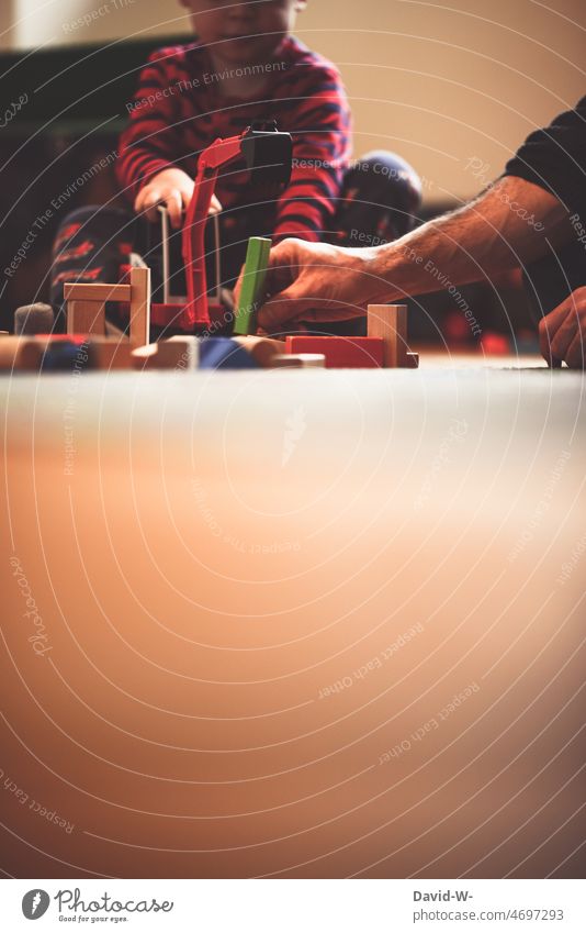 Father and child playing with building blocks on floor in children room Child Son Playing Children's room Toys Building bricks Excavator at the same time fun