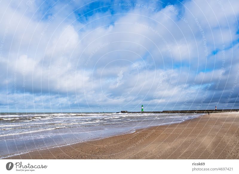 Beach and pier on the Baltic coast in Warnemünde Baltic Sea Mole Ocean Warnemuende Rostock Lighthouse pier light Mecklenburg-Western Pomerania Gale wave