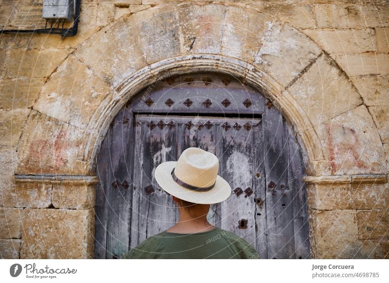 Rear view of a girl over vintage door background. close portrait. Concept travel, tourism, holidays boy rear little childhood kid caucasian one people young