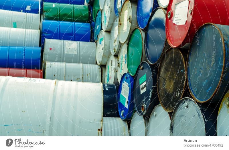 Old chemical barrels. Hazard chemical barrel with warning label. Steel tank of flammable liquid. Empty steel oil tank. Toxic waste warehouse. Hazard waste storage in factory. Metal brent oil drum.