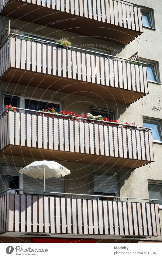 Old apartment building with balconies with balcony railings in beige and natural colors in the style of the post-war period in the summer in the sunshine in Sandweg in the Ostend of Frankfurt am Main in Hesse