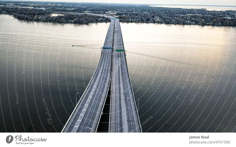 Highway over the lake with boat going under city road bridge highway car motion river day urban travel Bridge traffic transport Transport transportation