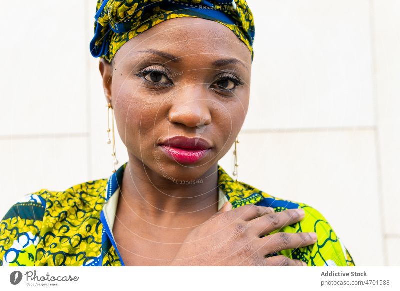 Stylish ethnic woman in ornamental wear looking at camera dreamily on street style elegant tradition dreamy authentic fashion portrait feminine local gorgeous