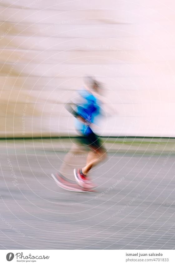 blurred man running on the street in Bilbao city, Spain marathon runner jogging action activity fitness health lifestyle jogger sport exercise athletic training