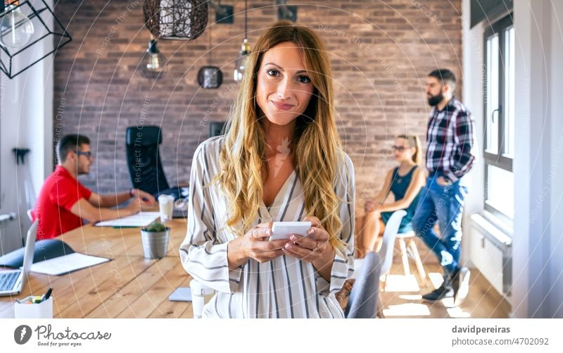 Smiling businesswoman looking at camera in office smiling looking camera friendly portrait coworking manager colleague meeting standing coworker