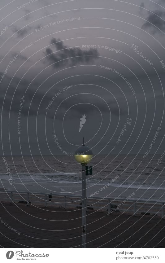 Street lamp at dusk intersecting exactly the sea horizon Landscape Ocean coast Twilight street lamp Evening Light Geometry Line Horizon somber Dreary Gray