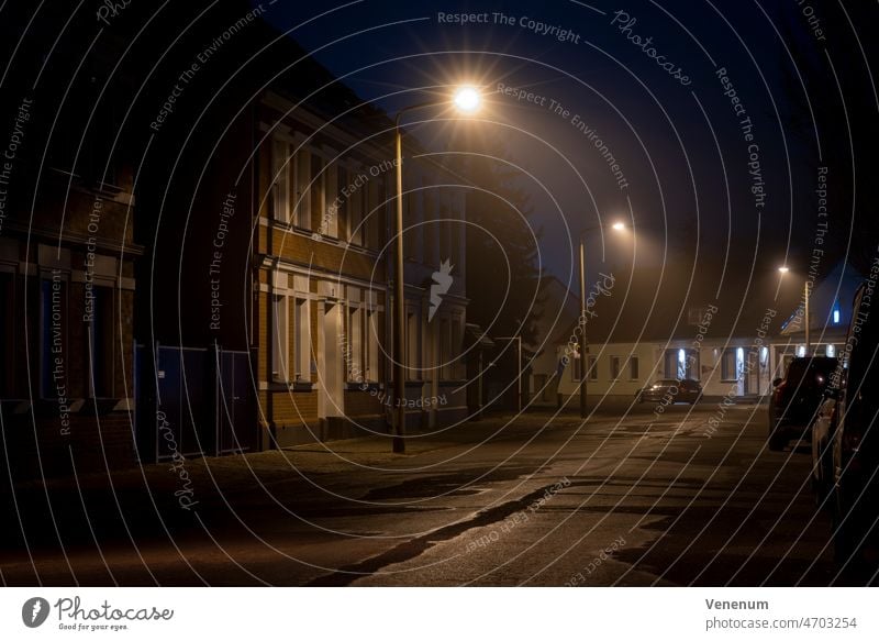 Germany,Luckenwalde, February 28, 2022,a little fog at night under the street lights Fog Foggy Mist Misty Street Streets Night Car Cars light post street lamp