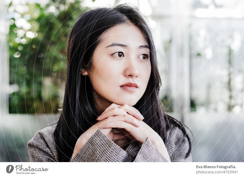 portrait of confident professional chinese entrepreneur woman in cafeteria. Technology, lifestyle asian laptop technology coffee tablet oriental business