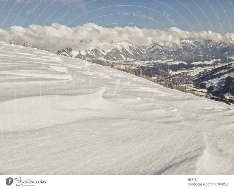 Icing on the cake from the sugar bakery nature. Wind shaped snow in foreground, mountains in background Snow layer Uniqueness snow-covered snowfield naturally