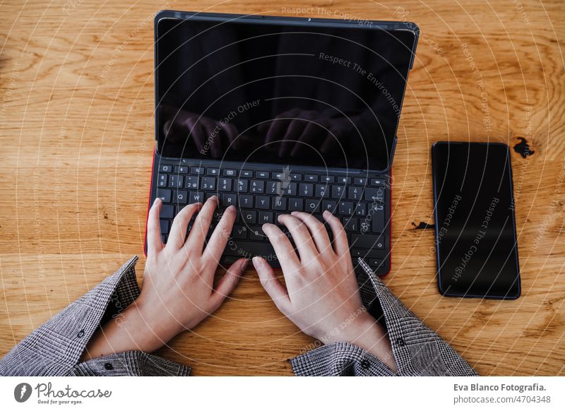 top view of business woman working in digital tablet and mobile phone in office. technology unrecognizable chinese asian laptop cafe coffee cafeteria oriental