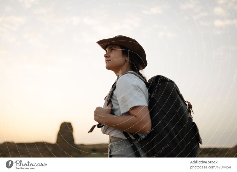 Traveler standing in desert field traveler trip adventure arid journey explore barren drought vacation dry bush vegetation hat vegetate waterless tourism