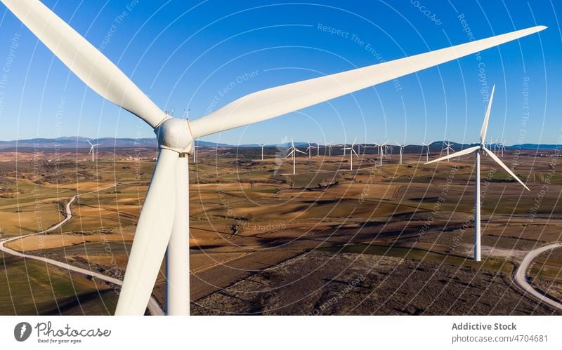 Windmills in field on sunny day windmill energy alternative renewal countryside innovation sustainable generator blue sky village cloudless Cantabria Spain