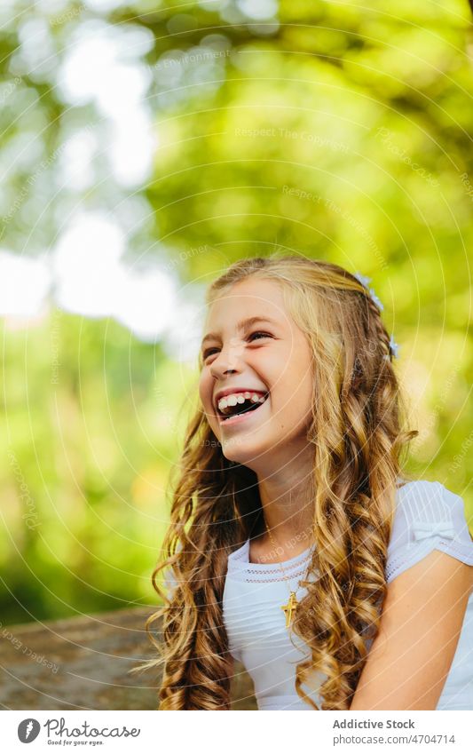 Happy girl sitting on bench with First Communion dress catholic communion religion first communion holy communion park happy woman smile cheerful child kid