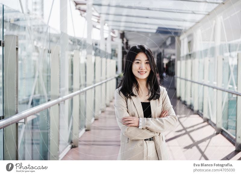 portrait of confident chinese business woman in building office. Technology asian laptop technology cafe coffee cafeteria tablet oriental mobile phone cheerful