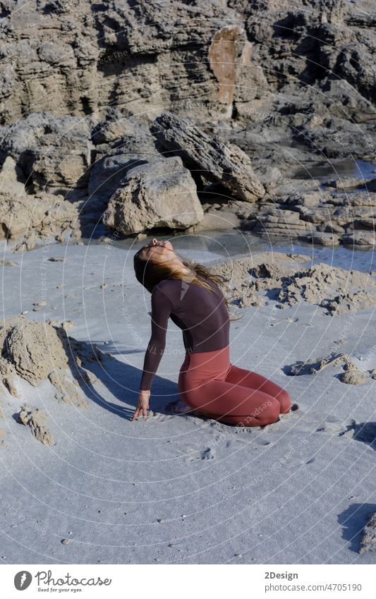 Young woman practice balance asanas on Summer yoga session on a beautiful beach at Formentera, Spain person relaxation sea exercise fitness sport body female