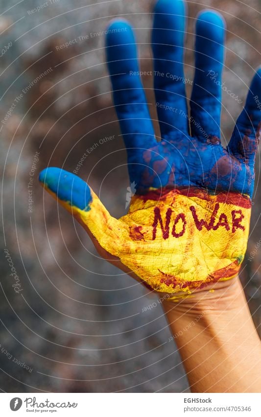 Female hand painted in the colors of the flag of Ukraine and blood. No war and peace concept. ukrainian flag independence poster support blue hands symbol