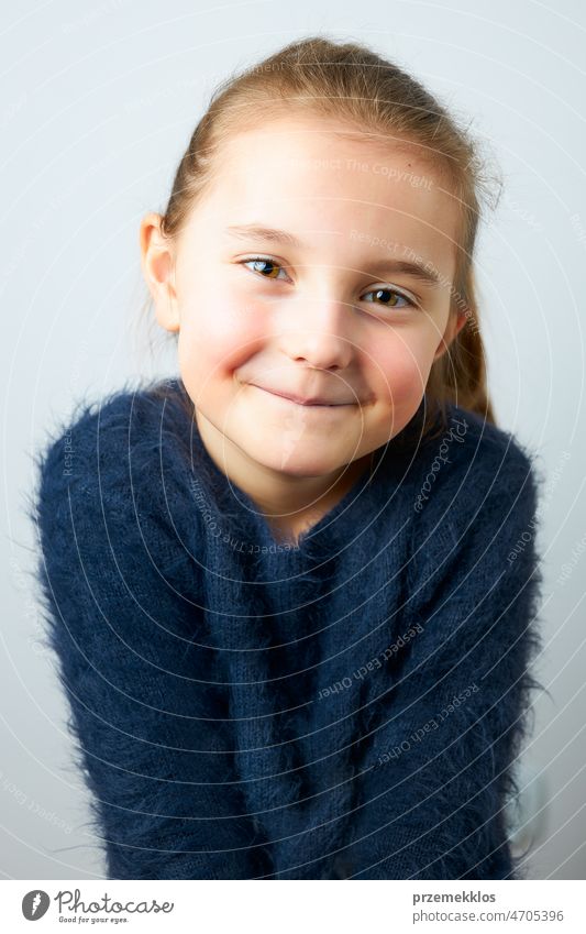 Portrait of adorable little girl. Cute small child looking at camera. Portrait of girl wearing blue sweater portrait cute person sweet smile happiness face