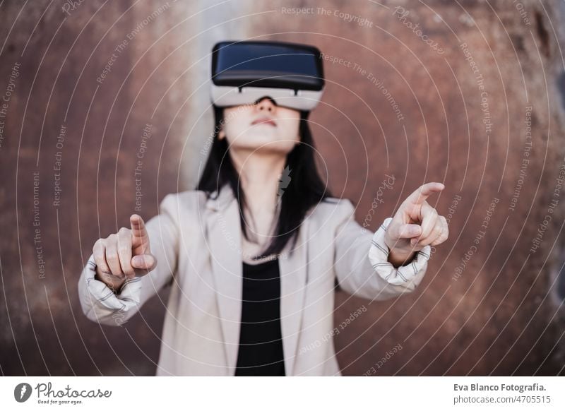 chinese Businesswoman using virtual reality headset. selective focus on hands. technology vr goggles meta verse attractive young game contraption lady smart