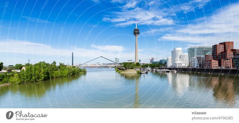 Blue Sky with clouds at summer in Dusseldorf. Rheinturm tower and a bridge, Nordrhein-Westfalen, Germany, Europe. dusseldorf germany river europe city rhine