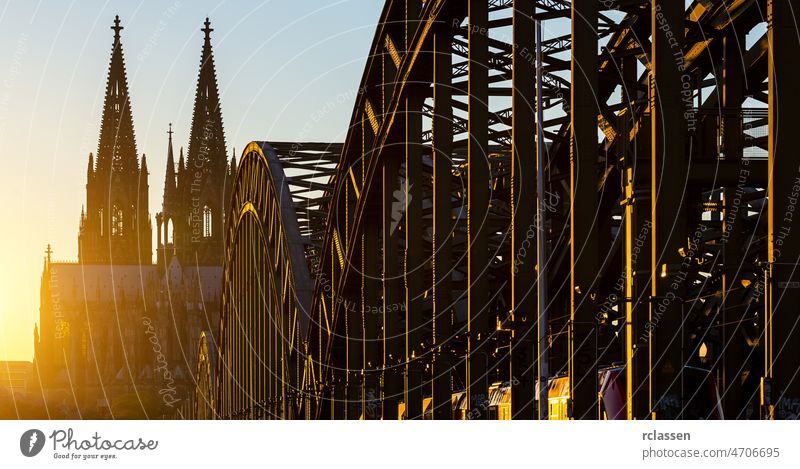 Cologne Cathedral at sunset city oldtown Rhine Hohenzollern Bridge Germany river church bridge dusk gothik tourism landmarks North Rhine-Westphalia rhineshore