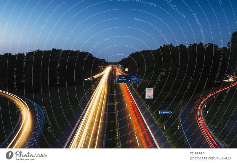 highway crossing with lighttrails at night motorway junction interchange aachen dawn auto freeway movement light-trail transportation logistics traffic sunrise