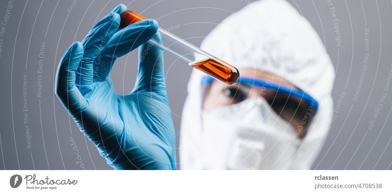 female medical lab worker holding 2019-nCoV Coronavirus blood Test tube. Positive Blood Sample in Scientist Hand. Coronavirus outbreaking, banner size