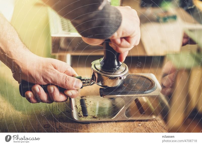 Barista prepares espresso in his coffeeshop barista fresh man art barman beverage vintage addiction adult bartender brew business portafilter cafe cafeteria