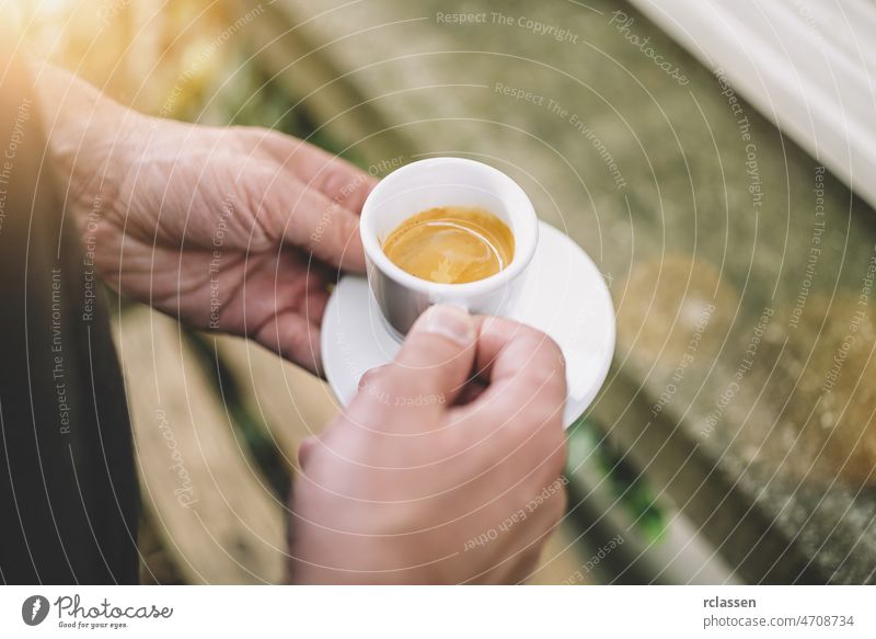 Man holding afresh tasty espresso cup of hot coffee in a cafe barista man tools art barman beverage crema dolce vita shop vintage addiction adult bartender brew