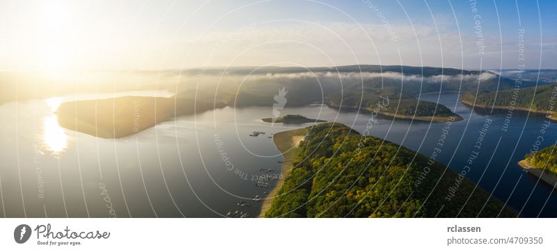 Sunrise at the Rursee lake in the Eifel National Park eifel rursee aerial blue drone green sunrise sunset national park nature outside panorama sun flare