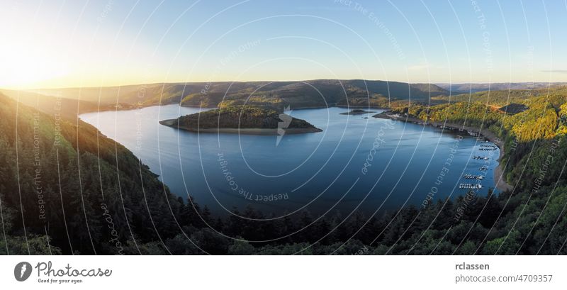 Sunrise at the Lake Rursee, Eifel Germany eifel rursee aerial blue drone green sunrise sunset national park nature outside panorama sun flare sunlight reservoir