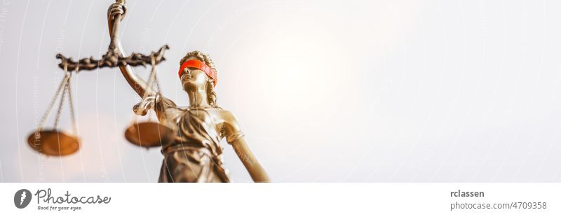 The Statue of Justice - lady justice or Iustitia / Justitia the Roman goddess of Justice with red blindfold, banner size, copyspace for your individual text.