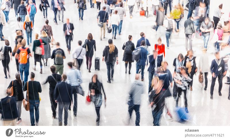 large crowd of anonymous blurred business people street walk city pedestrian busy movement downtown urban motion lifestyle traffic blurry background hour legs