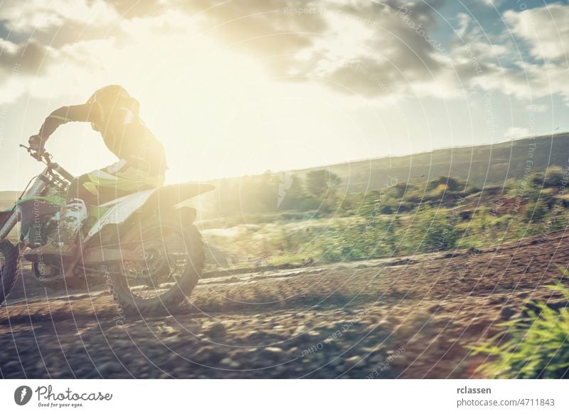 Motocross MX pilot in a turn during sunset on a dirt track motocross extreme bike enduro rally dirtbike dust rider speed trail motor motorcycle action