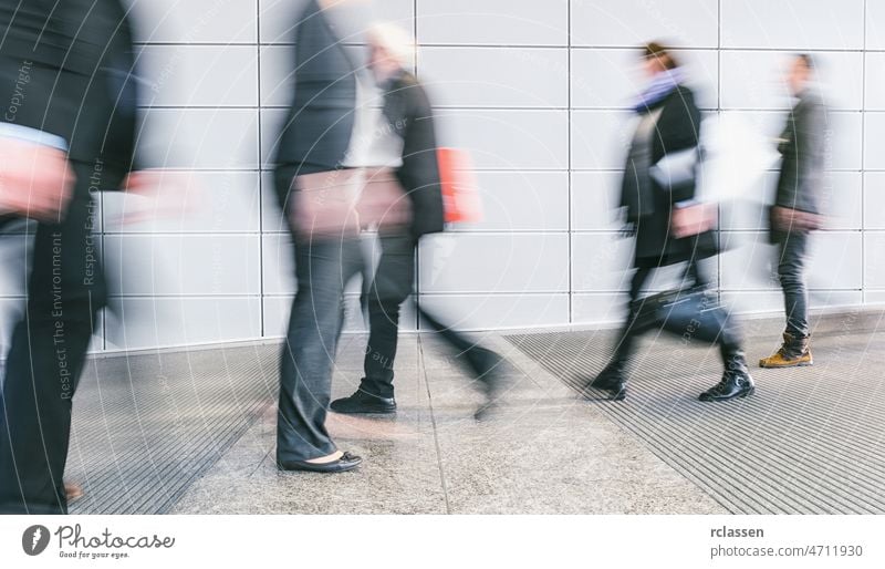 crowd of blurred people walking in a futuristic corridor trade fair show exhibition congress exit seminar visitors cologne travel future business hostess