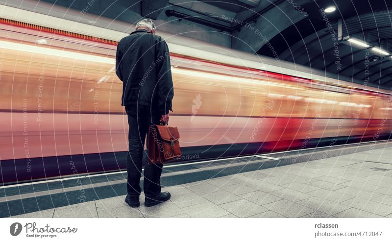 Business Commuter waiting for the next train in the London Underground underground station travel fast traffic move transport England Great Britain Subway red