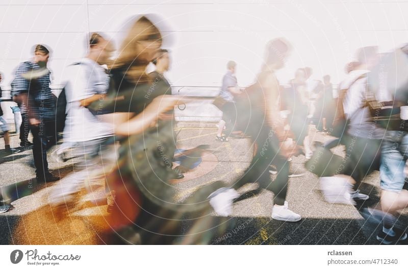 Anonymous crowd of people walking on a busy City street city new york blur abstract sidewalk population focus background white sun motion road shadow anonymous