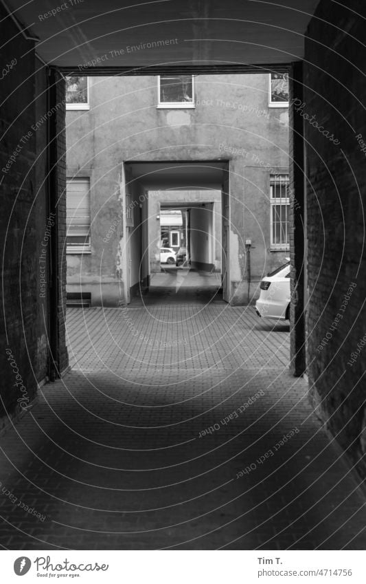 View through two gateways Backyard Kreuzberg b/w bnw Courtyard Berlin Black & white photo Day Deserted Town Exterior shot Downtown Capital city Building