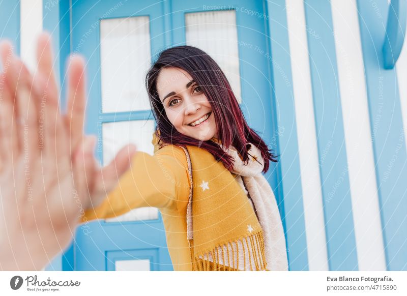 happy doing doing high five to friend in camera.colorful houses.promenade Costa Nova, Aveiro woman travel city aveiro costa nova portugal tourist tourism urban