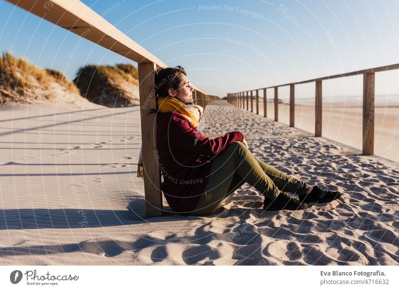 young woman with eyes closed relaxing at beach at sunset. Holidays and relaxation concept caucasian vacation holidays runway passage attractive pretty swimwear