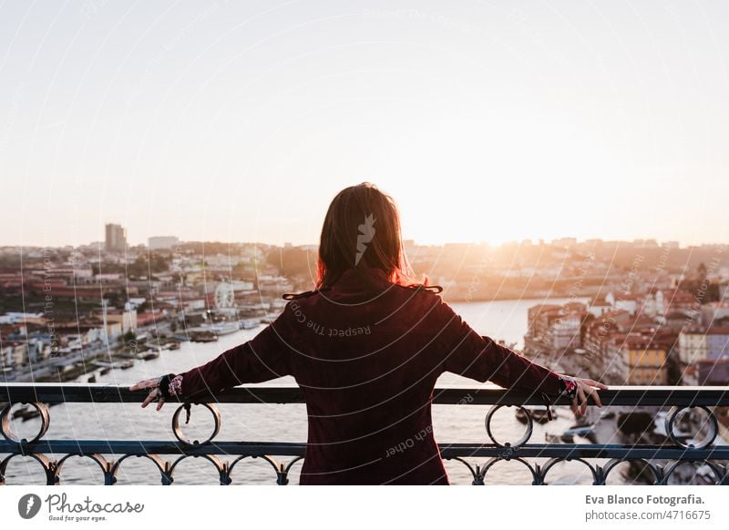 back view of relaxed woman in Porto bridge at sunset. Tourism in city Europe. travel and lifestyle porto tourist enjoy 30s holidays vacation urban high