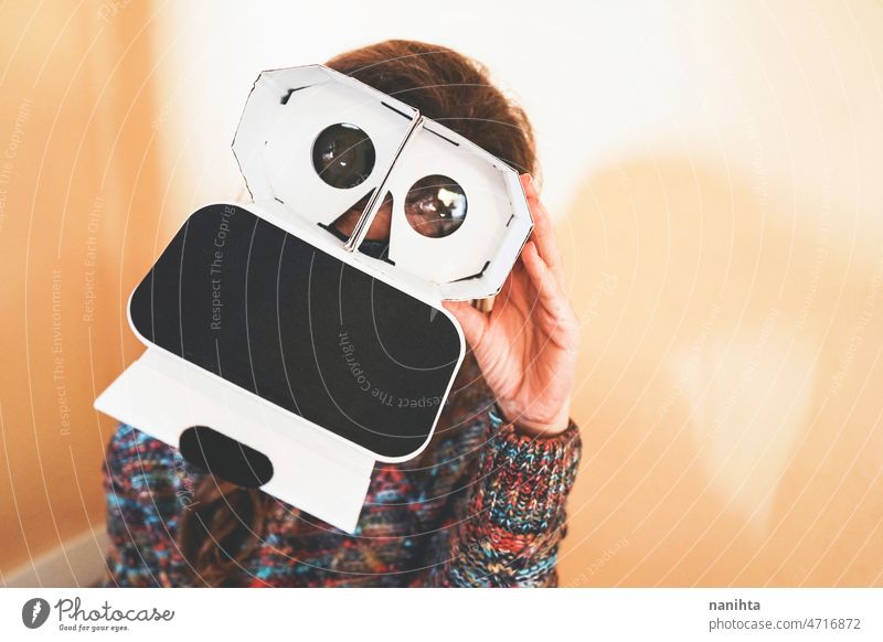 Image of a young woman showing the inside of a cardboard vr glasses metaverse lens technology sustainability playful gamer perspective weird nerd nerdy