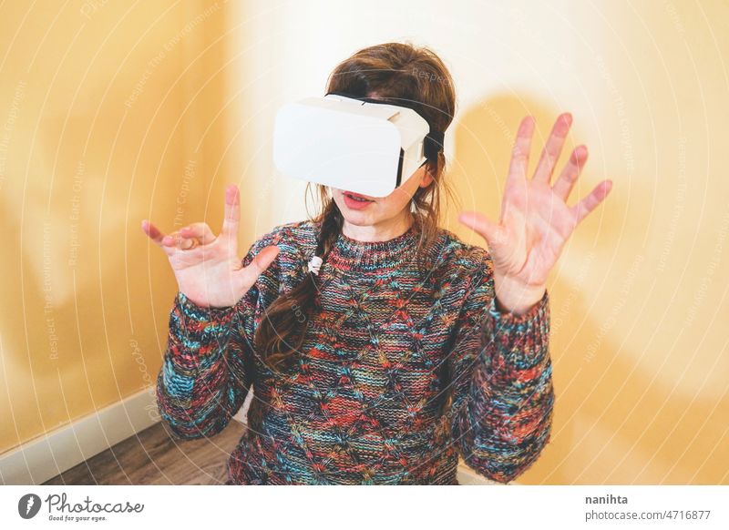 Spontaneous portrait of a young woman using cardboard vr glasses metaverse technology sustainability gamer virtual reality future progress concept surreal