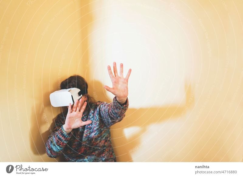 Spontaneous portrait of a young woman using cardboard vr glasses metaverse technology sustainability gamer virtual reality future progress concept surreal